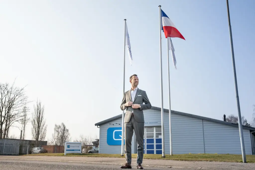 Q-Interline CEO Martin R. Henriksen in front of headquarters with French flag when opening French subsidiary