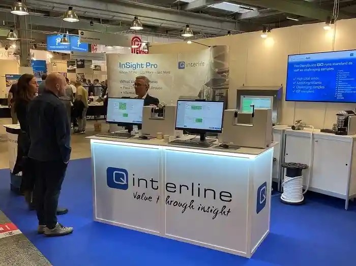 Q-Interline booth at a fair. We welcome you for instrument demos and to discuss how we can help your business.